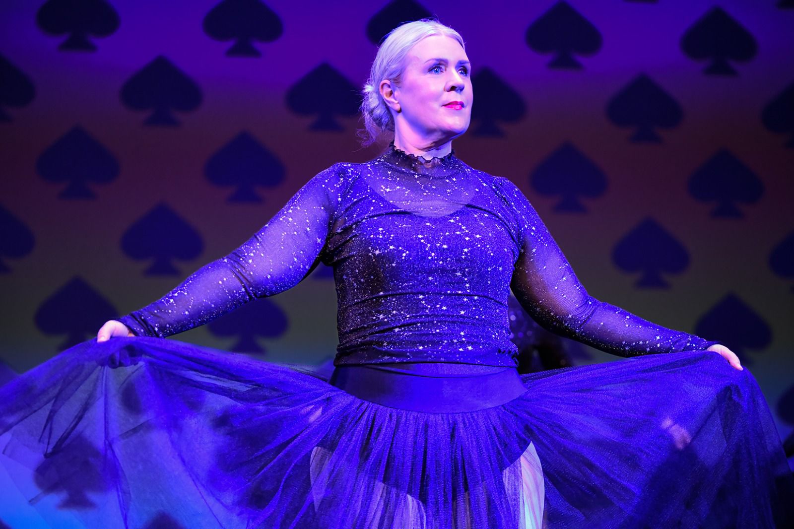 An adult ballet student performing on stage